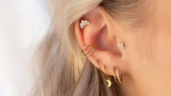 jeune femme avec plusieurs piercing sur l'oreille