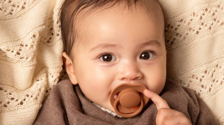 bébé avec tétine dans la bouche